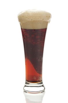 dark beer with the foam in a tall glass isolated on white