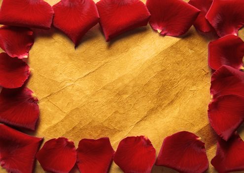 Border frame made with red rose petals over a vintage background 