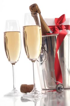 Glasses of champagne for Valentine's day with gift and ribbon