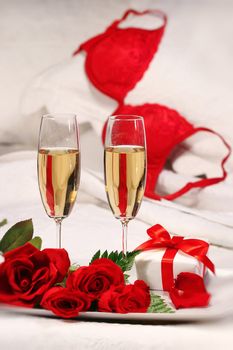 Closeup of champagne glasses and roses