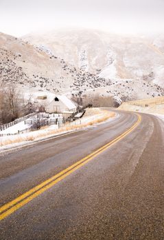 An icy road leads through country scene farm ranch hillside highway 71