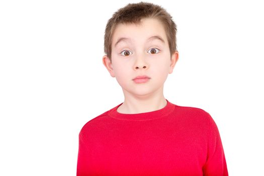 Cute young boy staring in amazement with a startled wide-eyed expression as he reacts in shock to something, isolated on white