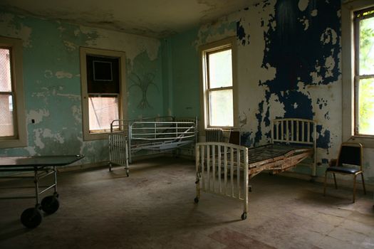 Abandoned Hospital Building With Empty Rusted Beds