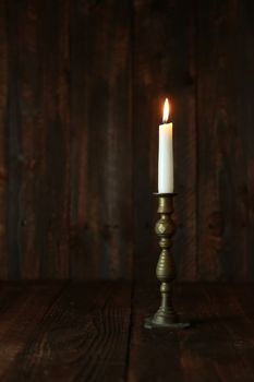 Candle on an Old Wooden Rustic Background