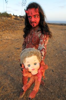 Latin American Man with Long Hairs Masked as a Devil in the Desert