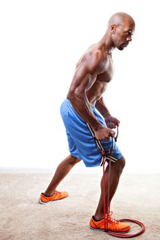 Ripped body builder working out  using a resistance band. 