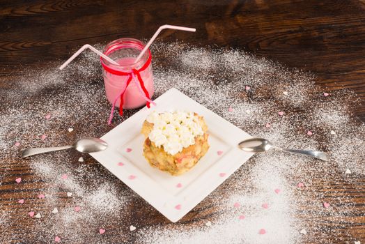 Heart shaped pastry with two spoons digging into it