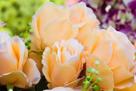 Yellow fabric roses,Fake textile yellow roses close-up floral background