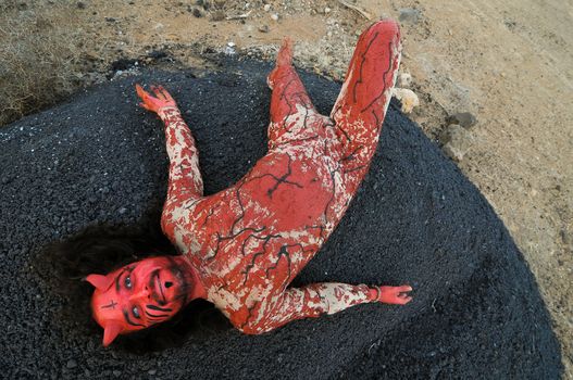 Latin American Man with Long Hairs Masked as a Devil in the Desert