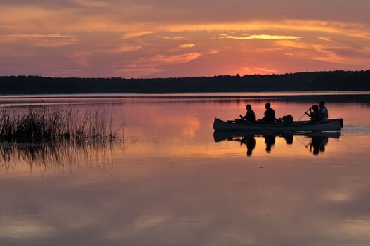 Two family bark Canoes at sunset in summer