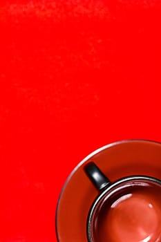 empty black-brown cup on a red background