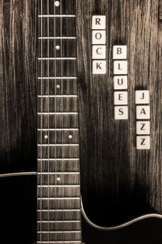 Monochrome detail of guitar and signs rock blues jazz in vintage style