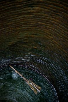 Broom floating in a well