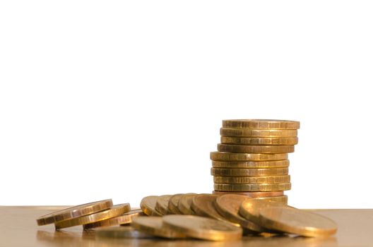 Coins scattered and located in a pile on white background