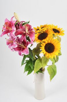 Studio shot of purple lily and sunflowers  in vase