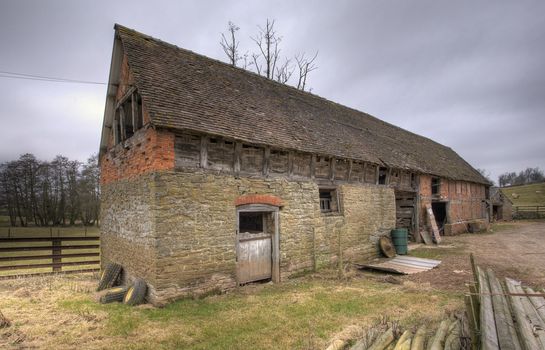 Stone barn with traditional wattle infill panels, Shropshire, England.