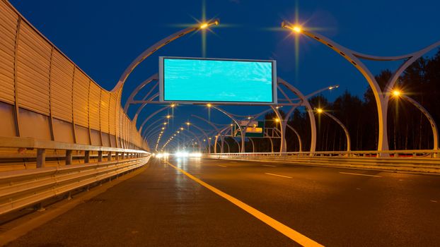 Empty big billboard on night highway