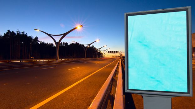 Big empty billboard on night highway