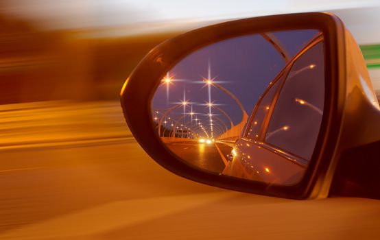 Reflection of high-speed road on car mirror 