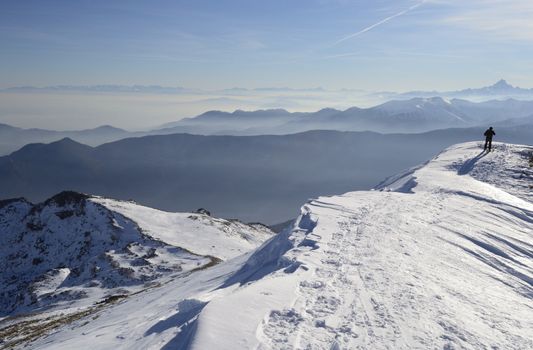 Alpinist on the top of the mountain in wonderful alpine scenery with high mountain range in the backgrounds