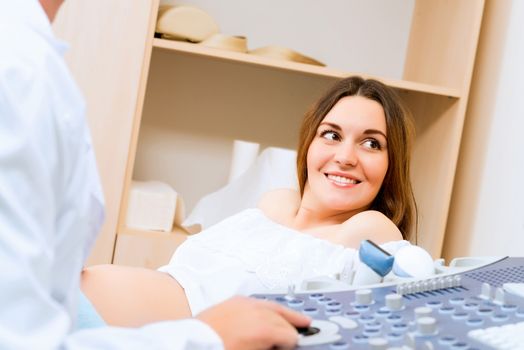 Young attractive pregnant woman on reception at the doctor, health check