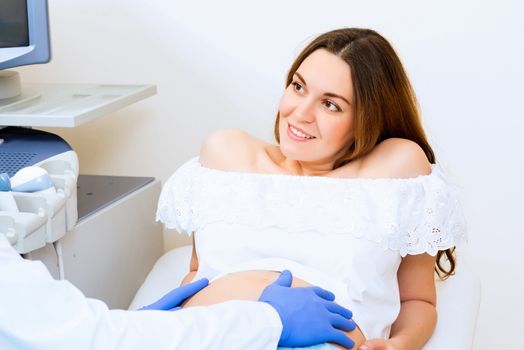 Young attractive pregnant woman on reception at the doctor, health check