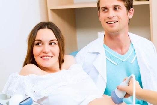 pregnant woman and the future father of the doctor's office, ultrasound diagnostics