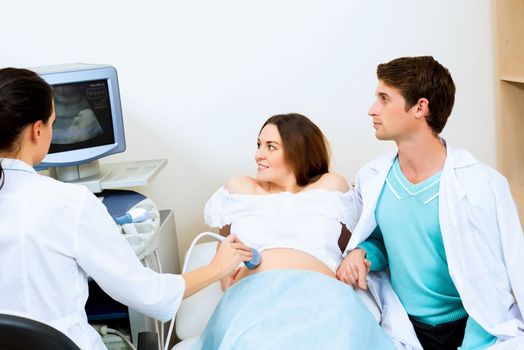 pregnant woman and the future father of the doctor's office, ultrasound diagnostics