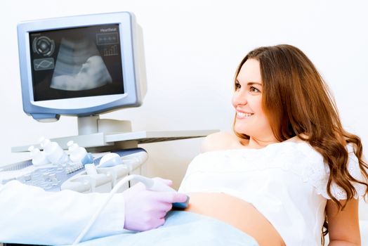 Young attractive pregnant woman on reception at the doctor, health check