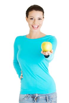 Young woman holding green fresh apple, isolated over white background