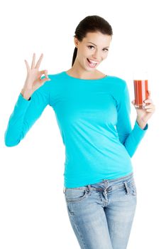 Happy smiling woman drinking tomato juice and gesturing perfect