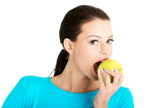 Young woman holding green fresh apple, isolated over white background