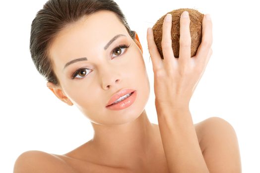 Beautiful woman with coconut in hands over white background