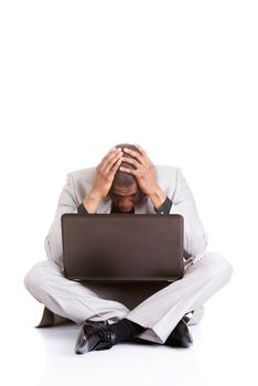 Stressed businessman working on laptop, isolated on white