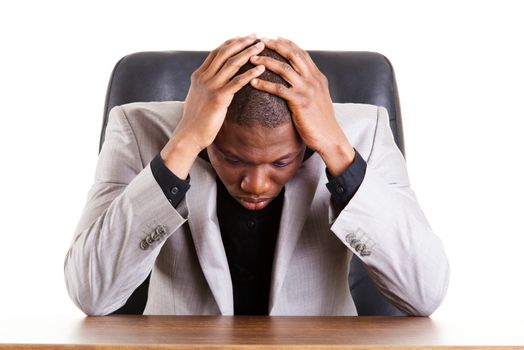 Sad, tired or depressed businessman at the desk.