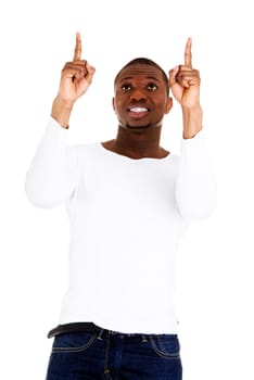 Happy young man pointing at something interesting over white background