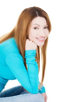 Happy attractive woman sitting, isolated on white