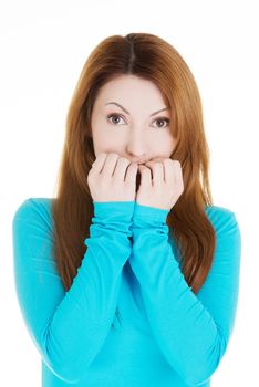 Stressed young woman eating her nails , isolated on white.