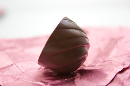 Chocolate candy on a pink wrapping.