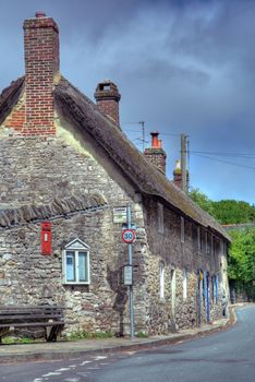 Row of stone, terraced thatched cottages, West Lulworth, Dorset, England.