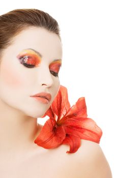 Beautiful woman with a red lily, isolated on white