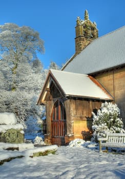 The small stone church at Cofton Hackett in snow, Worcestershire, England.