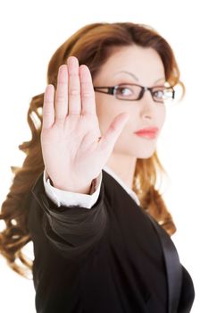 Serious business woman gesturing stop sign, isolated on white