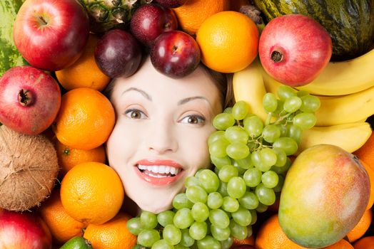 Woman face in fruits, healthy nutrition and diet concept.