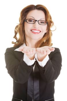 Happy business woman showing copy space on her palm, isolated on white