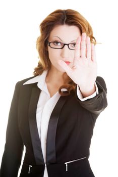 Serious business woman gesturing stop sign, isolated on white