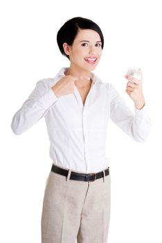 Businesswoman showing led bulb, isolated on white