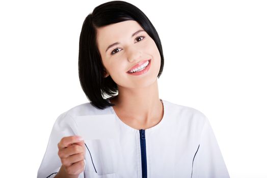 Woman doctor or nurse holding business card in her hand