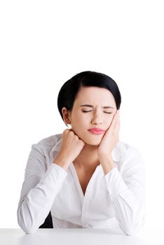 Young woman in pain is having toothache isolated on white