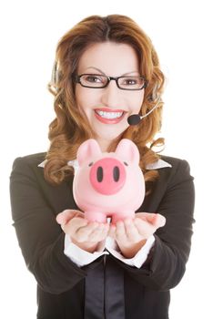 Business woman with headset holding piggy bank , isolated.